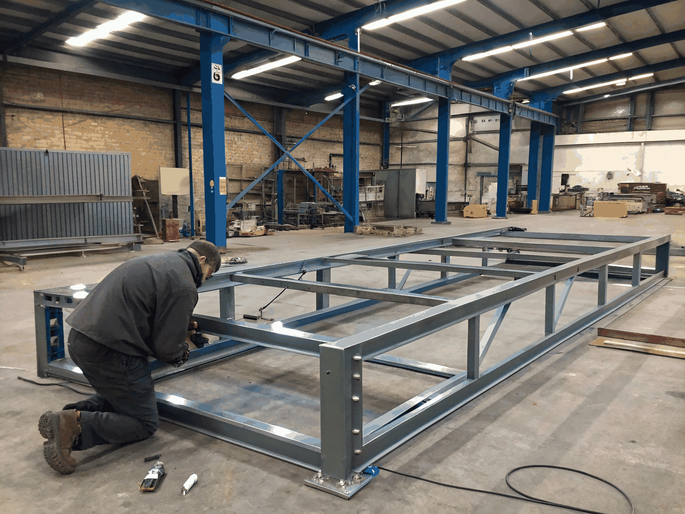 Assembly bench showing corner joins and reinforcement of custom facade panel